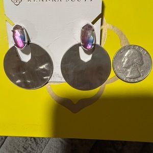 KENDRA SCOTT SILVER EARRINGS WITH IRIDESCENT PURPLE AND BLUE CRYSTALS.